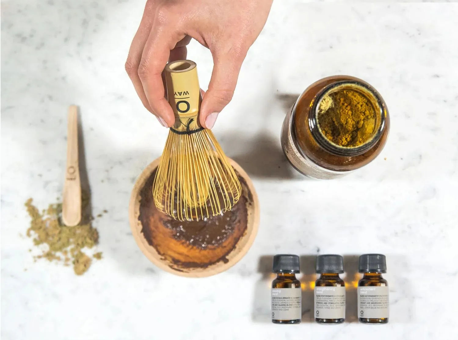 Botanical herbs and clay laid out for a scalp detox ritual
