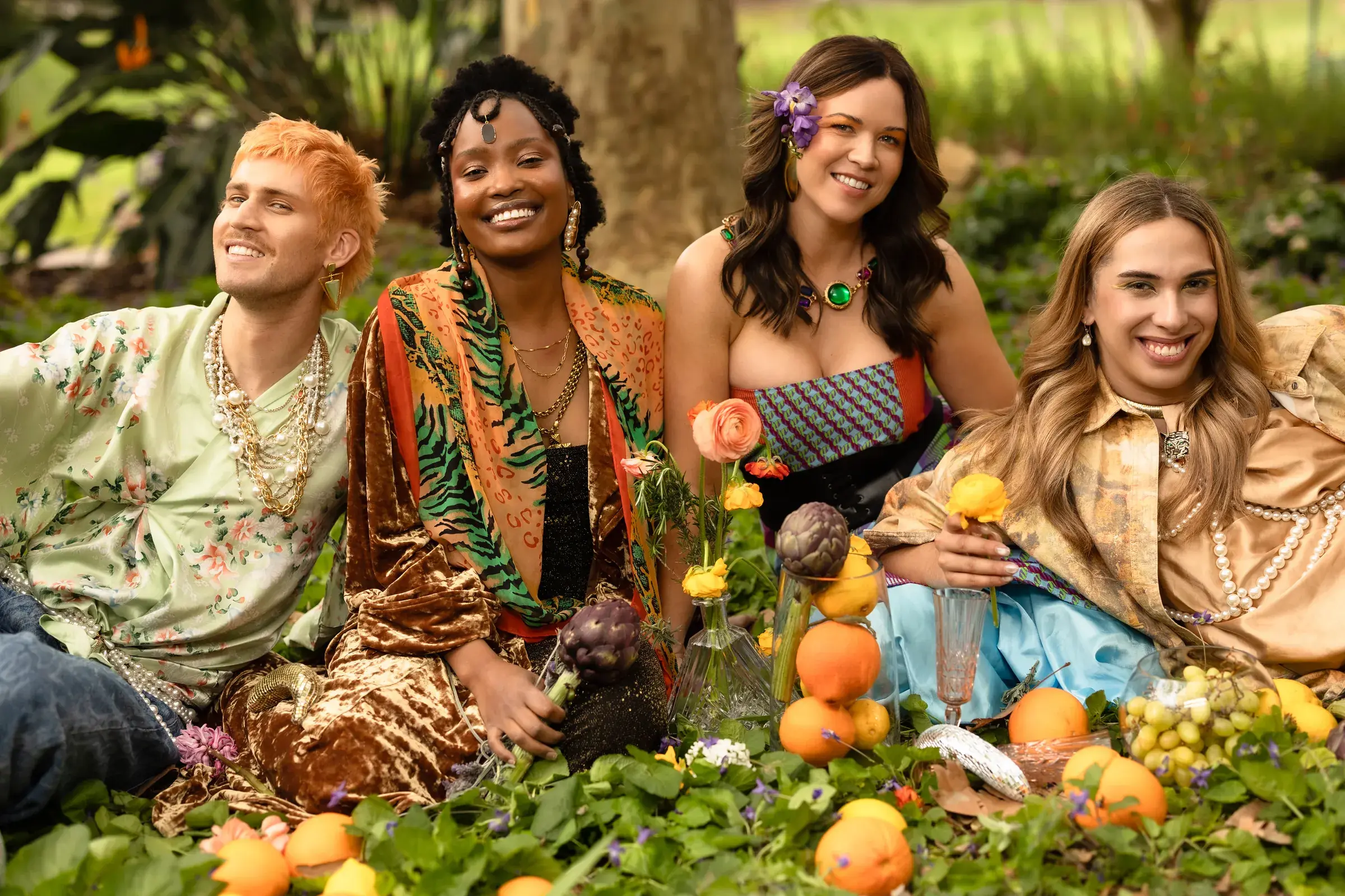 Four diverse models styled by Curjo Hair in a lush garden setting