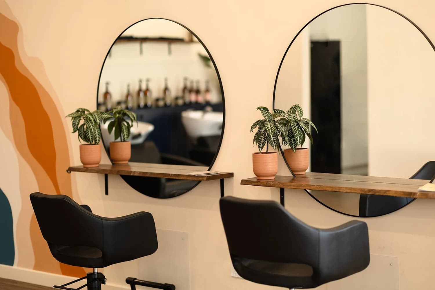 Calm Curjo Hair salon interior with styling chairs and warm lighting
